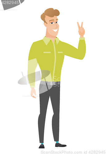 Image of Caucasian businessman showing the victory gesture.
