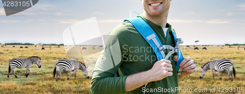 Image of close up of happy man with backpack traveling