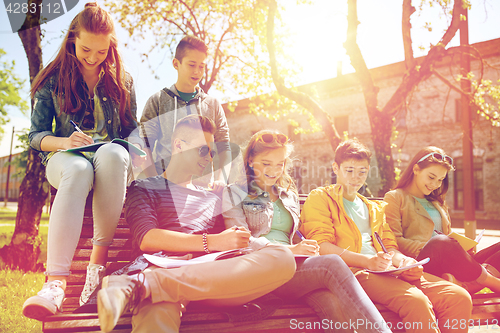 Image of group of students with notebooks at school yard