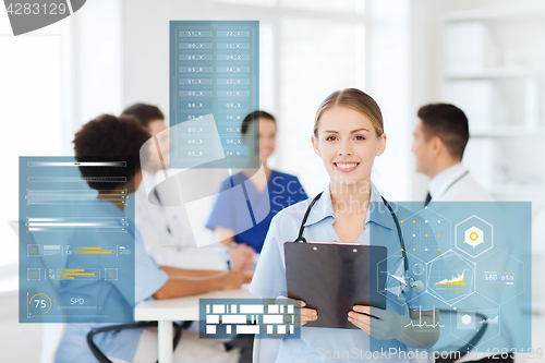 Image of happy doctor with clipboard at hospital