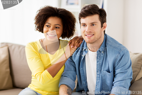 Image of happy smiling international couple at home