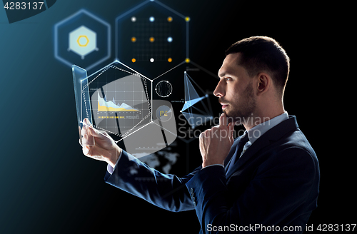 Image of businessman working with transparent tablet pc