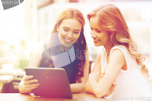 Image of happy young women or teenage girls with tablet pc