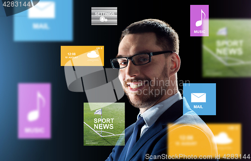 Image of smiling businessman in glasses over black