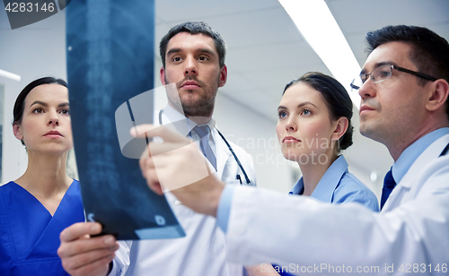 Image of group of doctors looking at x-ray scan image