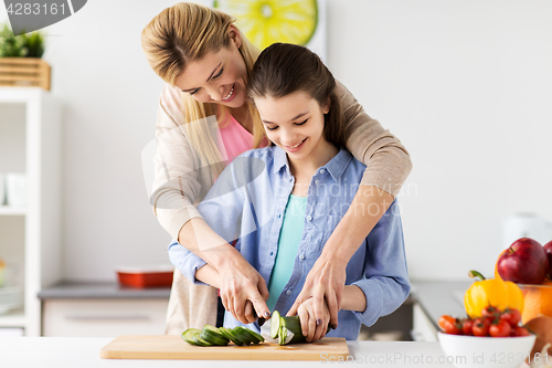 Image of happy family cooking dinner at home kitchen