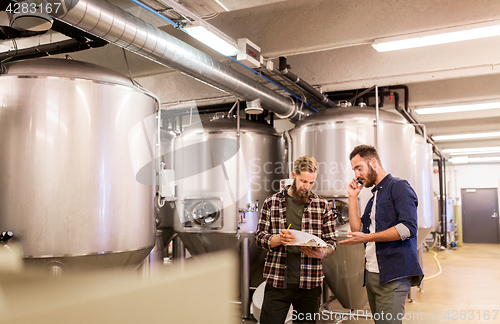 Image of men working at craft brewery or beer plant