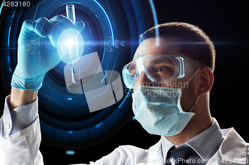 Image of scientist with test tube and virtual projection