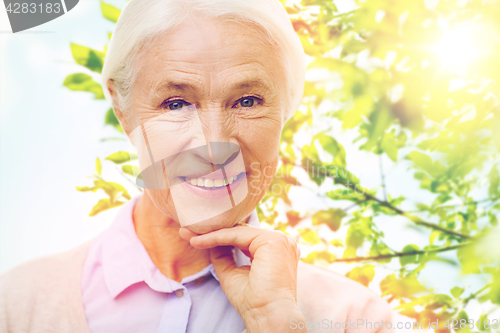 Image of happy senior woman over green natural background