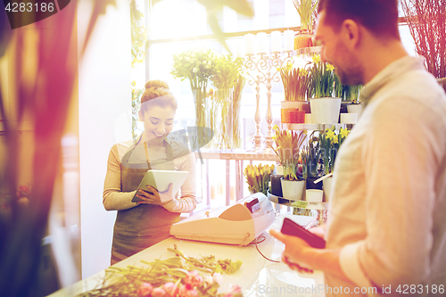 Image of florist woman and man making order at flower shop