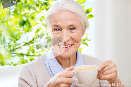 Image of happy senior woman with cup of coffee