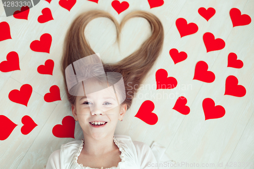 Image of One little girl lying on the floor.