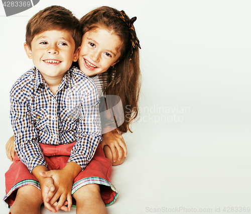 Image of little cute boy and girl hugging playing on white background, ha