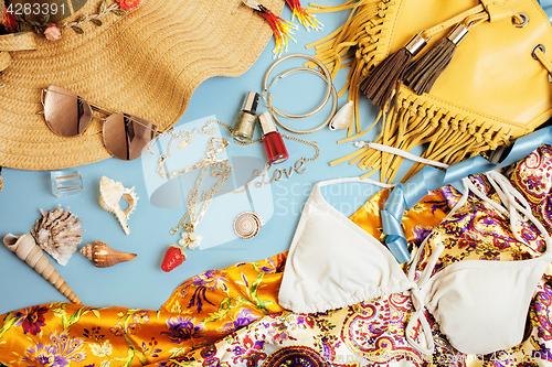 Image of diverse travel girlish stuff on colorful background blue and yellow, nobody tourism lifestyle concept