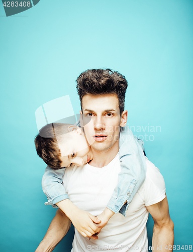 Image of young pretty man model with little cute son playing together, lifestyle modern people concept, family male 