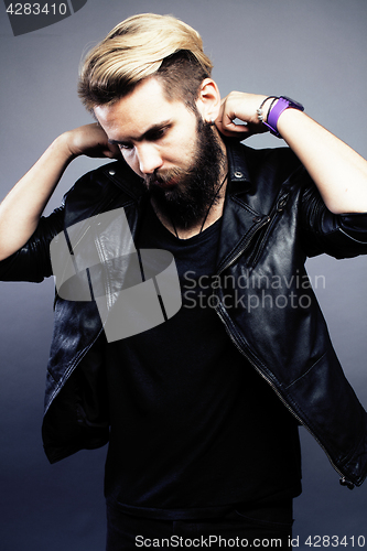 Image of portrait of young bearded hipster guy on gray dark background close up, brutal modern man, lifestyle people concept 