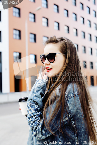 Image of young pretty hipster girl student with coffee cup posing adorable smiling, lifestyle people concept outdoor