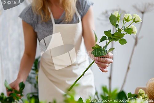 Image of Young girl florist with flowers