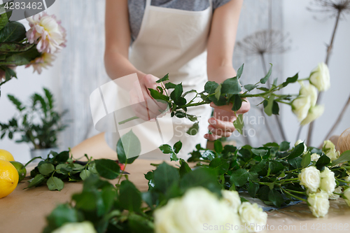 Image of Young florist woman with roses