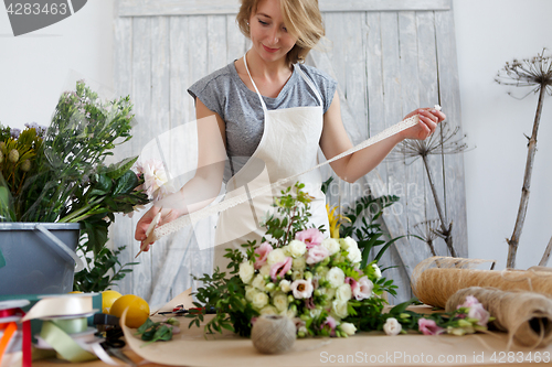 Image of Florist with beautiful bouquet , ribbon,