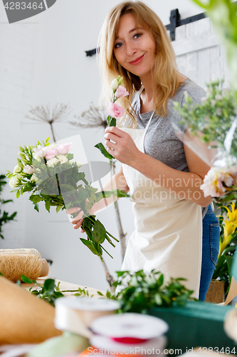 Image of Smiling florist in flower shop