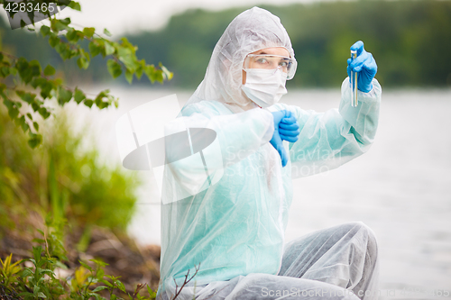 Image of Biologist with test tube in mask