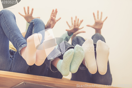 Image of happy children which are sitting on the stairs in the house.