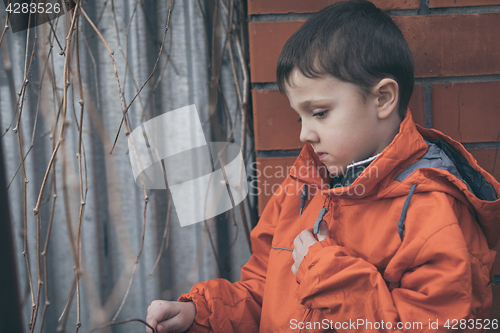 Image of Portrait of sad little boy