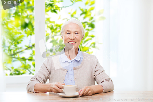 Image of happy senior woman with cup of coffee