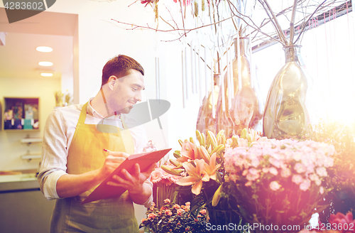 Image of florist man with clipboard at flower shop