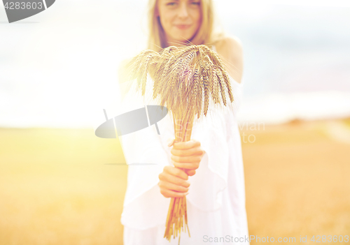 Image of close up of happy woman with cereal spikelets