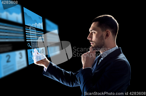 Image of businessman with tablet pc and exchange charts