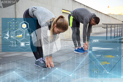 Image of couple stretching and bending forward on street