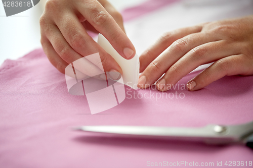 Image of woman with pattern and chalk drawing on fabric