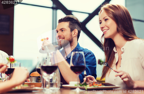 Image of happy couple having dinner at restaurant