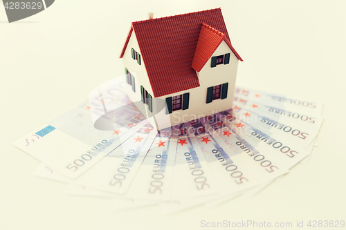 Image of close up of home or house model and money