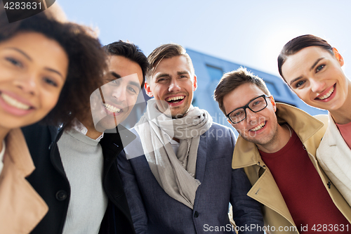 Image of group of happy people or friends on city street