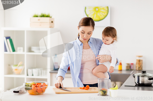 Image of happy mother and baby cooking food at home kitchen