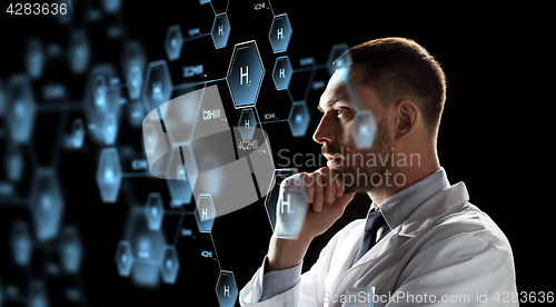 Image of scientist looking at chemical formula projection