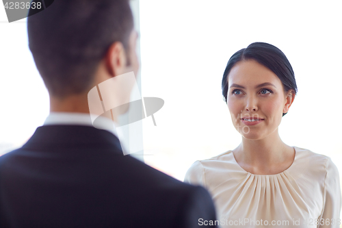 Image of smiling business man and woman at office