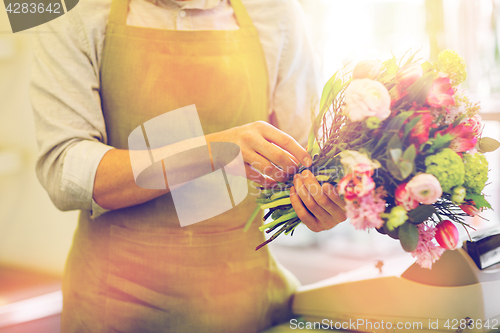 Image of close up of man making bunch at flower shop