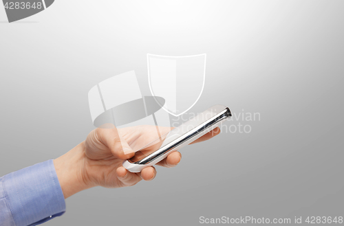 Image of woman with smartphone and antivirus program icon