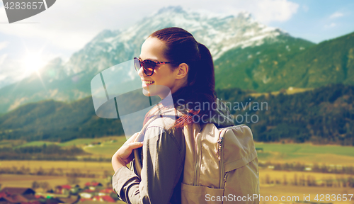 Image of happy woman with backpack traveling in highlands