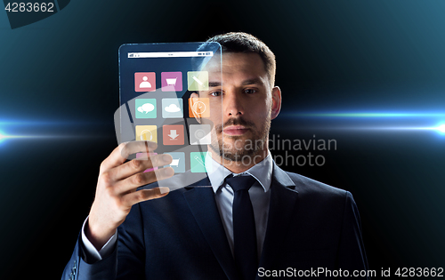 Image of businessman working with transparent tablet pc