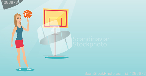 Image of Young caucasian basketball player spinning a ball.