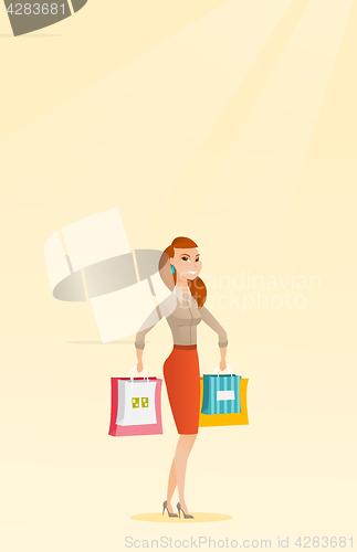 Image of Young happy caucasian woman with shopping bags.