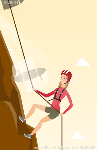 Image of Caucasian woman climbing a mountain with rope.