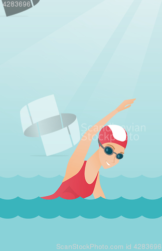 Image of Young caucasian sportswoman swimming.