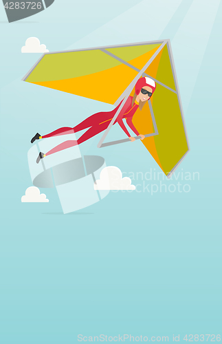 Image of Young caucasian woman flying on hang-glider.