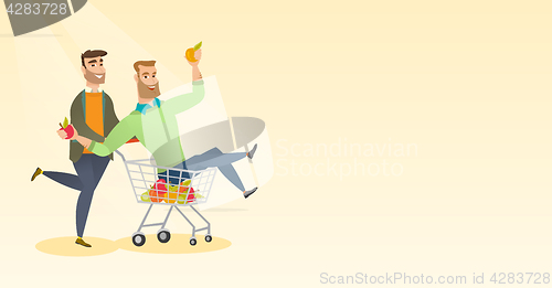 Image of Couple of friends riding in shopping trolley.